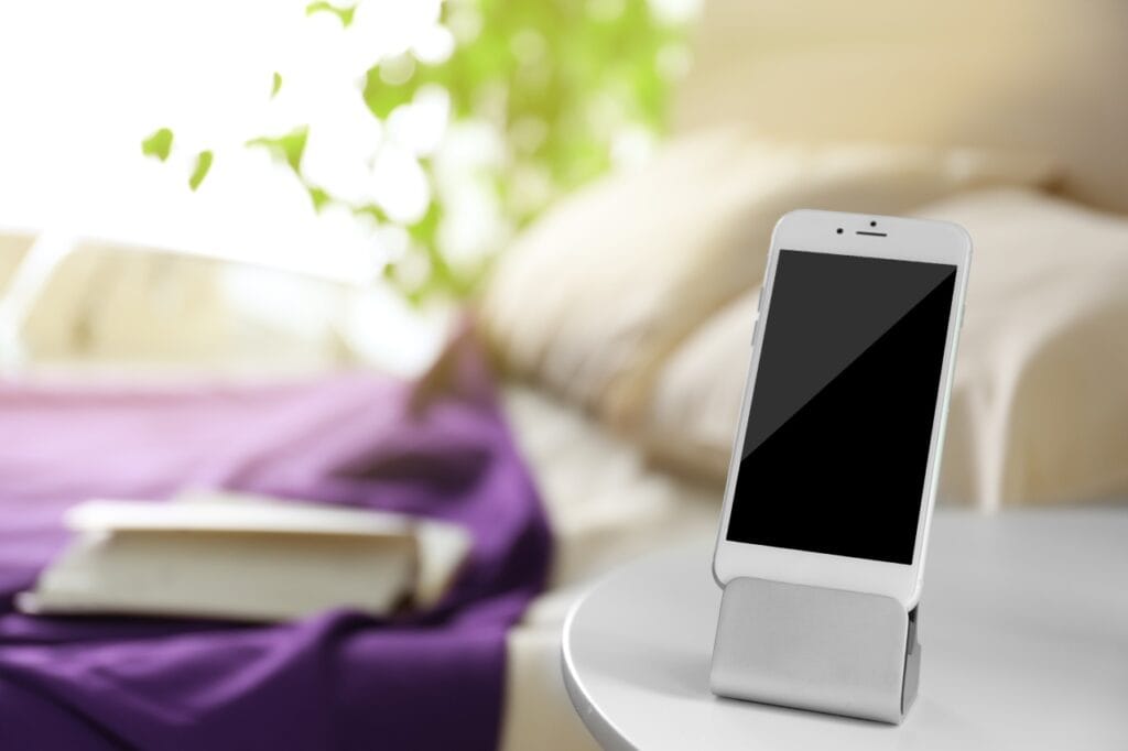Suportul ideal: combinația perfectă între design și materiale de calitate Accesoriu durabil pentru telefon – suport din aluminiu pe birou alb, lângă pat