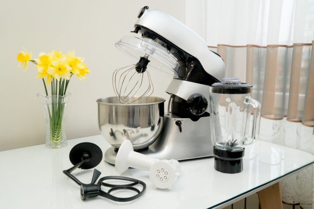 Robot de bucătărie multifuncțional cu bol inox, blender și accesorii pe masă, sfaturi pentru întreținere corectă