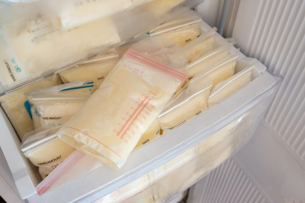 congelator organizat cu pungi de stocare lapte matern, etichetate și stivuite eficient